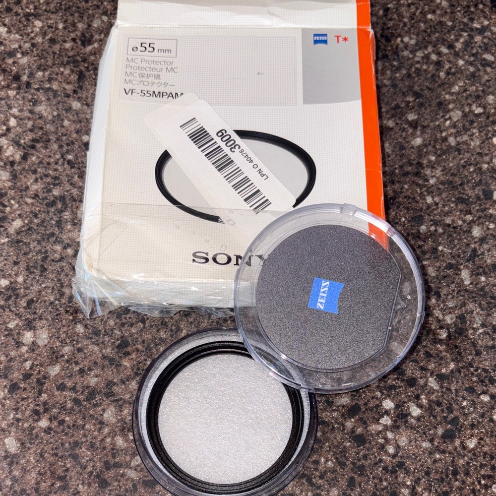 Sony Black Camera Lens Filter and Zeiss Clear Filter Cap